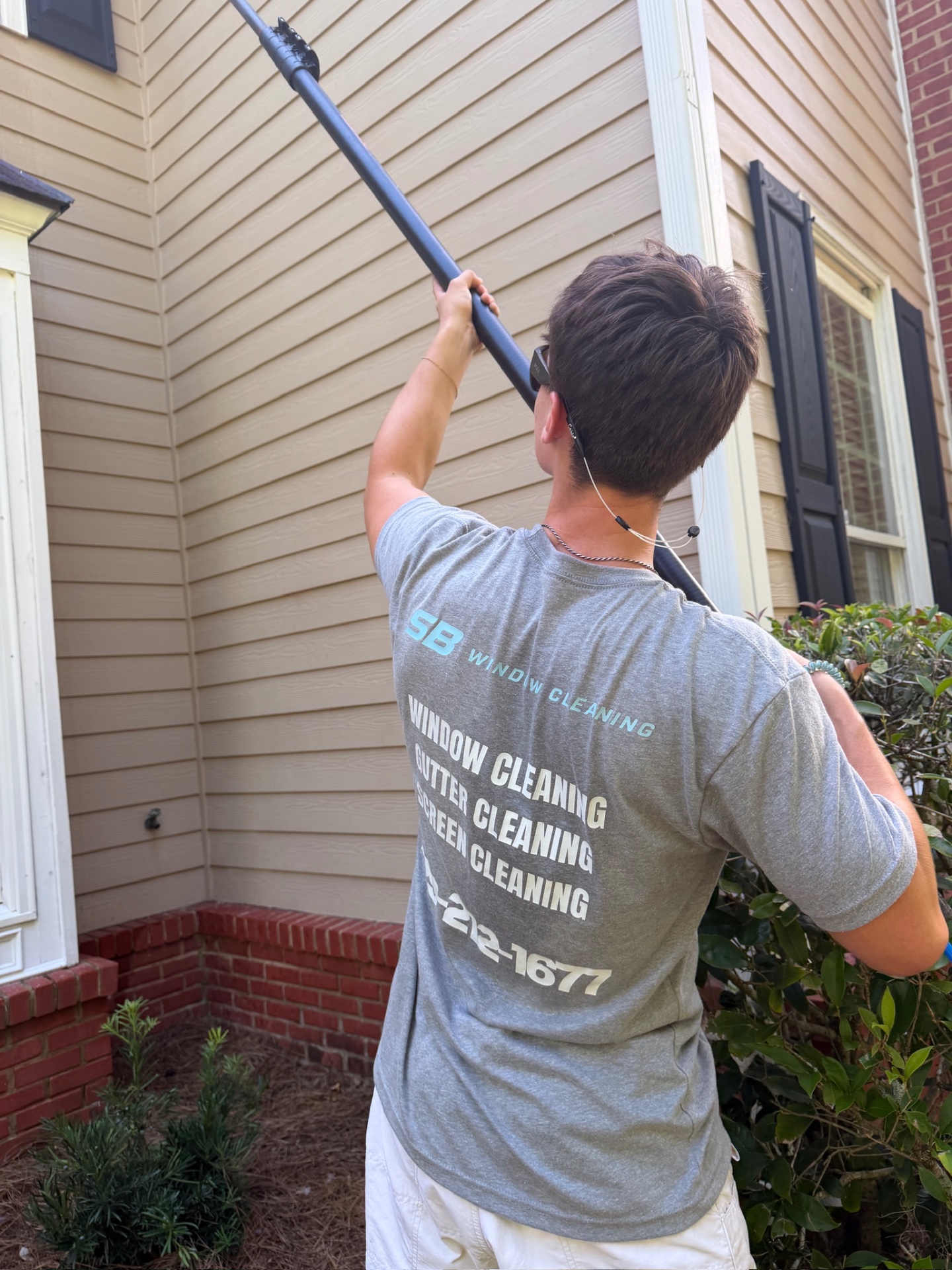 Professional window cleaner squeegeeing a streak-free window